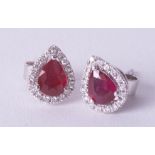 A pair of 18ct ruby and diamond pear shaped earrings.