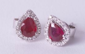 A pair of 18ct ruby and diamond pear shaped earrings.