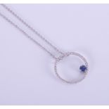 A modern 18ct white gold pendant and chain, in the form of a diamond circle with an off set