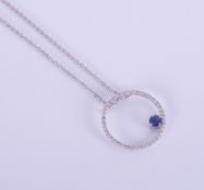 A modern 18ct white gold pendant and chain, in the form of a diamond circle with an off set