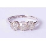 An 18ct and platinum diamond three stone ring, approx 1.20 carats, size N.