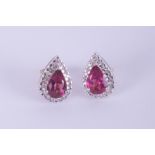 A pair white gold pink tourmaline and diamond pear shape cluster earrings.
