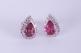 A pair white gold pink tourmaline and diamond pear shape cluster earrings.