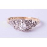 An 18ct and platinum diamond single stone ring, fancy raised setting, size L.