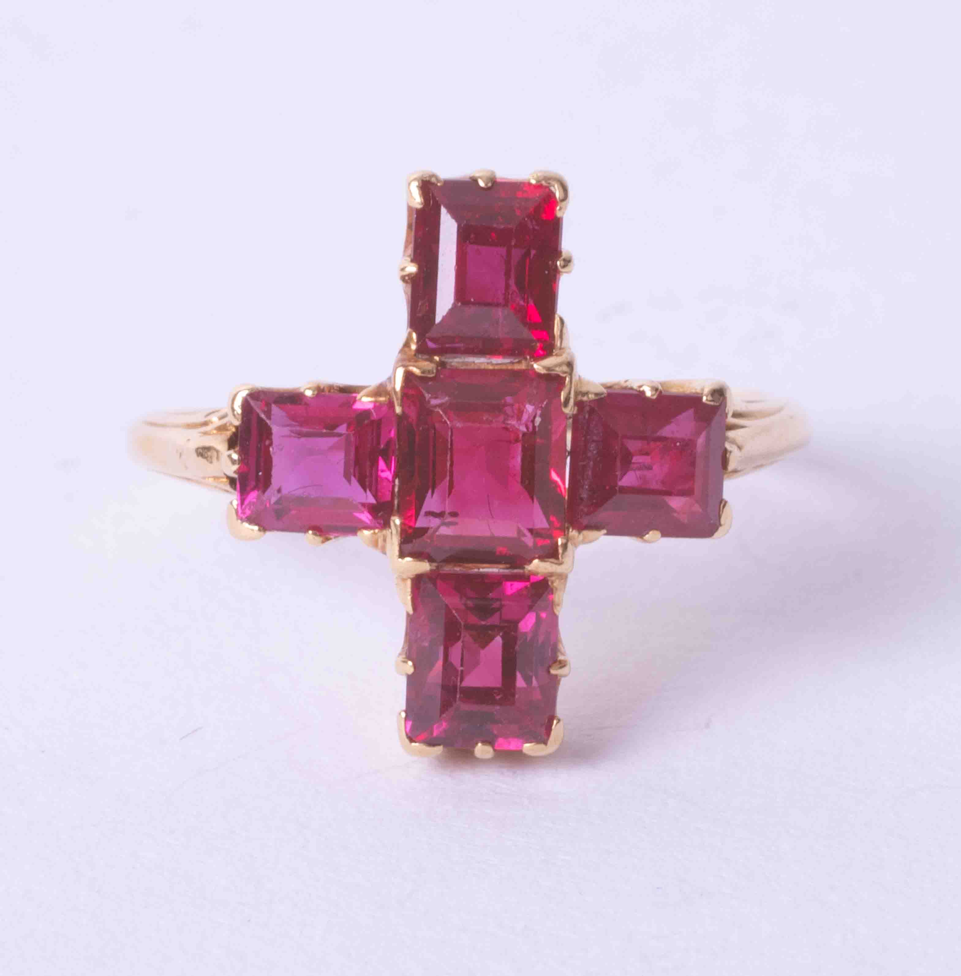 An antique ruby 'cruciform' five stone ring of good colour, circa 1900, size I.