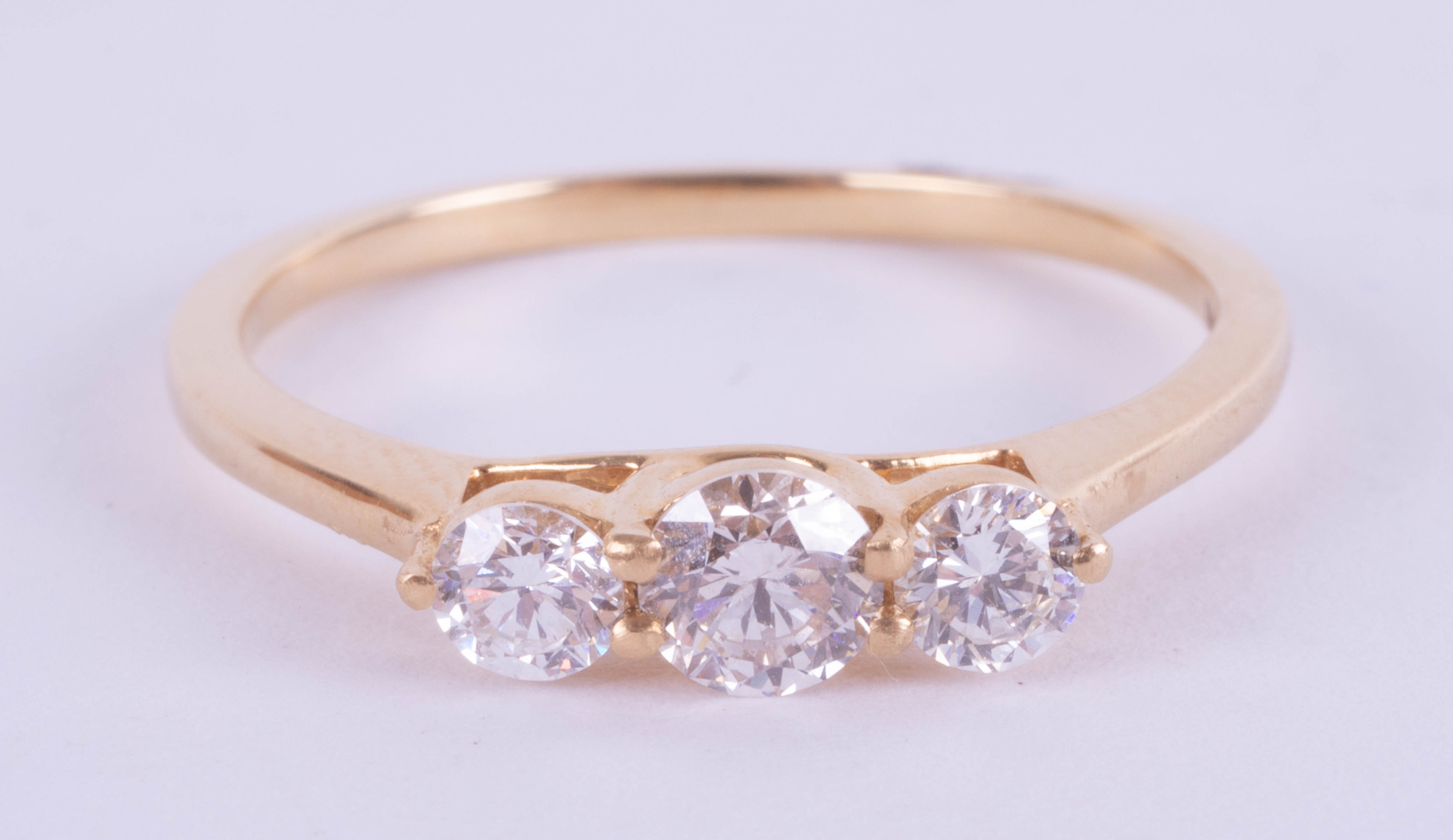 An 18ct yellow gold trilogy ring approx. 0.50ct, estimated colour and clarity E/SI1, ring size M.