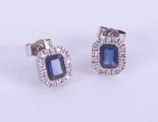 A pair 18ct white gold, diamond and sapphire cluster earrings.