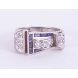 An Art Deco sapphire and diamond ring of Cartier style, size Q. In a sculptural asymmetric Art