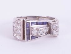 An Art Deco sapphire and diamond ring of Cartier style, size Q. In a sculptural asymmetric Art