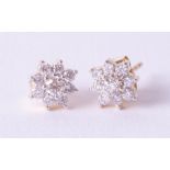 A pair of 18ct diamond set cluster earrings.
