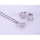 An 18ct white gold and diamond set pendant and earring set.