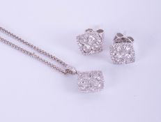 An 18ct white gold and diamond set pendant and earring set.