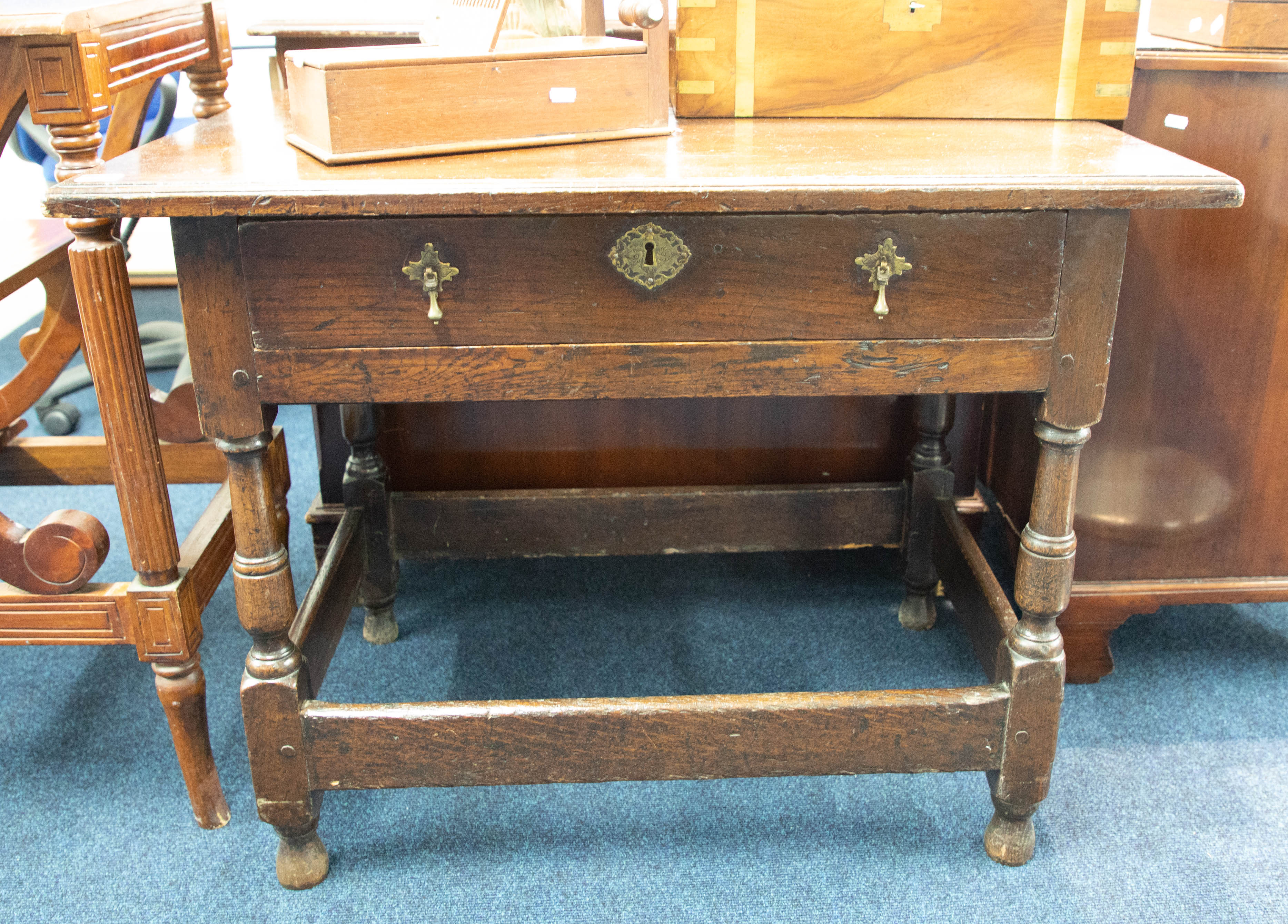 An antique oak side table, fitted with a single drawer on turned legs with stretchers, width 90cm.