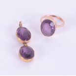 An amethyst and yellow metal ring and a double amethyst pendant for a necklace.
