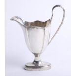 A silver cream jug with graduated fluted oval body, oval foot with rising ribbed handle, Chester