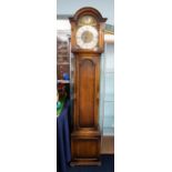 An oak Grandmother clock, circa 1920, with three train chiming movement and brass cased weights,