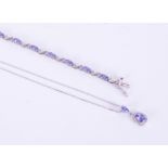 A 14ct tanzanite and diamond pendant necklace on fine chain and also a silver tanzanite style