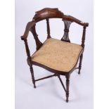 An Edwardian corner chair.