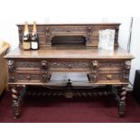 A Victorian heavily carved oak desk with upper section fitted with drawers over a base with