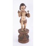 A polychrome carved wood figure of a statue of baby Jesus with orb, height 61cm.