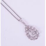 A diamond pear-shaped pendant necklace set in white metal.