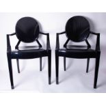A pair of black Louis Ghost Armchairs by Kartell.