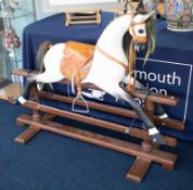 A large rocking horse around 30 years old with leather saddle.