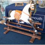 A large rocking horse around 30 years old with leather saddle.