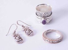 A silver and amethyst type dress ring, another silver dress ring, and a pair of silver modern