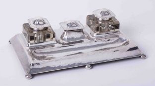 An Art Nouveau silver inkstand on bun feet.