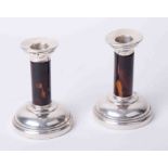 A pair of silver and tortoise shell candlesticks, faults, height 13cm.