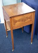 An Edwardian inlaid mahogany sewing stand with fitted interior on small brass casters.