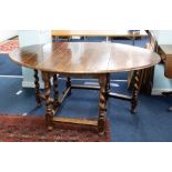 An oak gate-leg table with barley twist legs, together with a set of eight upholstered dining chairs