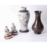Pair oriental seated figures with famille verte painted decoration, sat on matching decorative