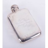 A silver hip flask with inscription dated 1917, height 14cm, approximately 4.80oz.