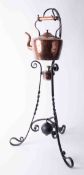 Copper kettle on wrought iron stand, height 80cm.