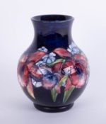 William Moorcroft, a baluster shaped vase, decorated with flowers, signed in green, height 25cm.