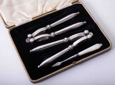 Edwardian cased set of silver plated nut crackers & mother of pearl picker In good condition,