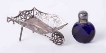 A miniature silver wheelbarrow and a miniature coloured glass scent bottle (2).