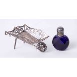 A miniature silver wheelbarrow and a miniature coloured glass scent bottle (2).