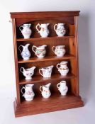 A collection of twelve Worcester Royal Historic porcelain jugs with certificates and display rack.