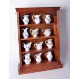 A collection of twelve Worcester Royal Historic porcelain jugs with certificates and display rack.