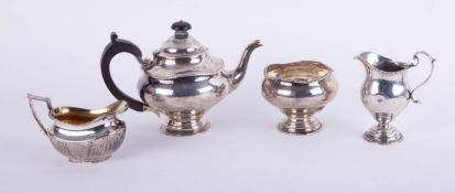 A Geo V three piece silver tea service (JH) approximately 18.50oz, a silver and gilt cream jug