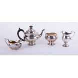 A Geo V three piece silver tea service (JH) approximately 18.50oz, a silver and gilt cream jug