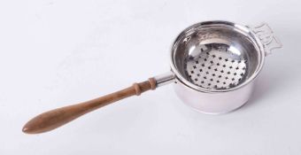 Solid silver tea strainer and stand with decorative pierced bowl, wooden shaped handle and