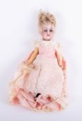 A small size antique doll with bisque head, open close eyes, composition body, damaged leg.