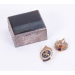 A white metal square pill box together with a Scottish thistle brooch and a meritorious service