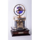 A Franklin Mint National Geographic Society Millenium clock, eight-day movement, glass dome, 32cm