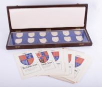 The Royal Arms silver collection of twelve heraldic shield crests in fitted case with card