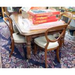 A mahogany dining table with a central insertable extension leaf with original winding handle height